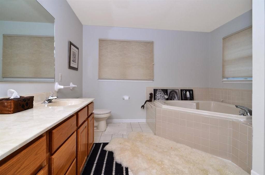 A bathroom with two sinks and a bathtub