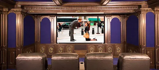 Home theater showing a movie scene of a man proposing to a woman.