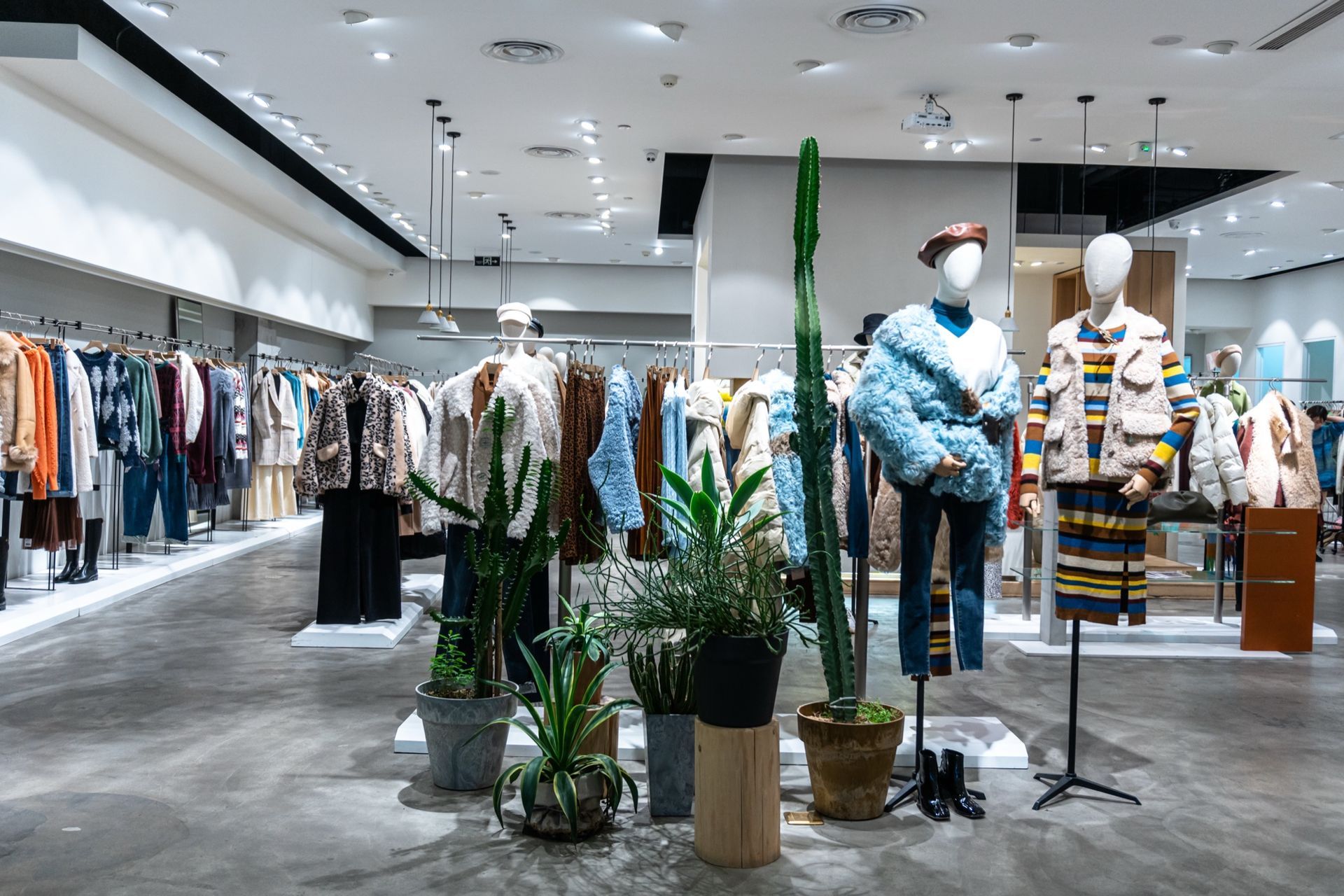 A Modern Office Features a Dark Wood Cabinet, a Sleek Desk with A Computer, an Office Chair, and A Blank Wall Frame.