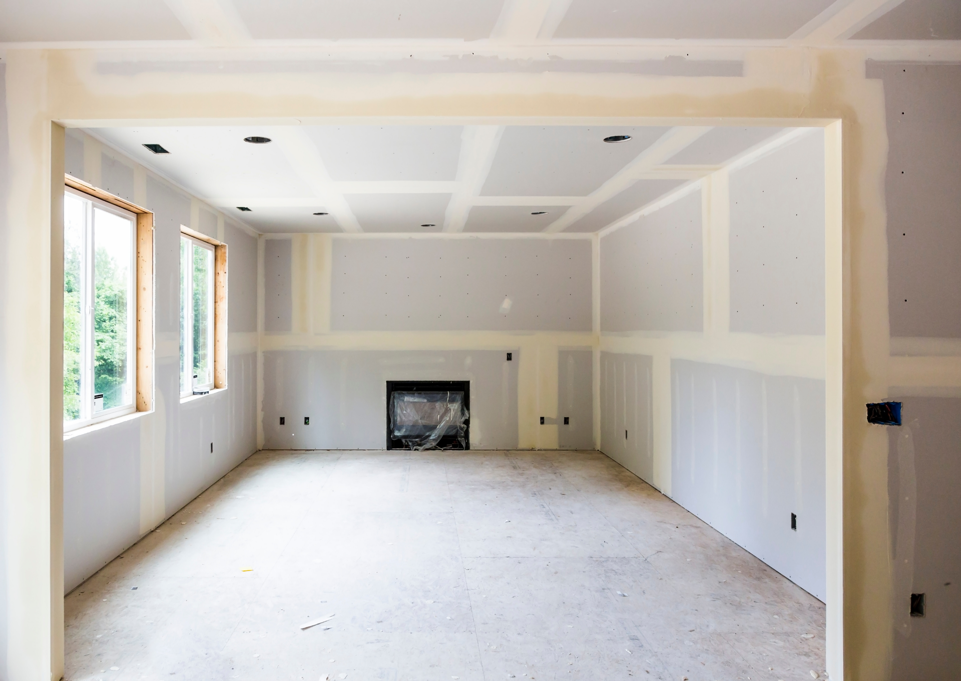 An empty room with a fireplace in the middle of it