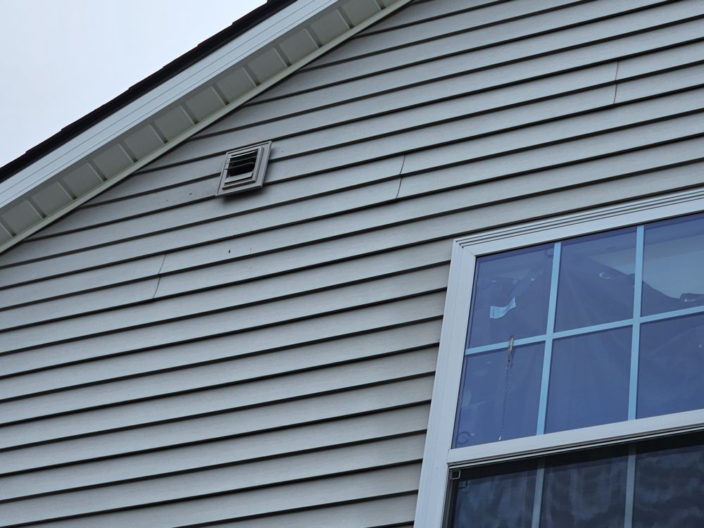 A close up of a house with a window and siding