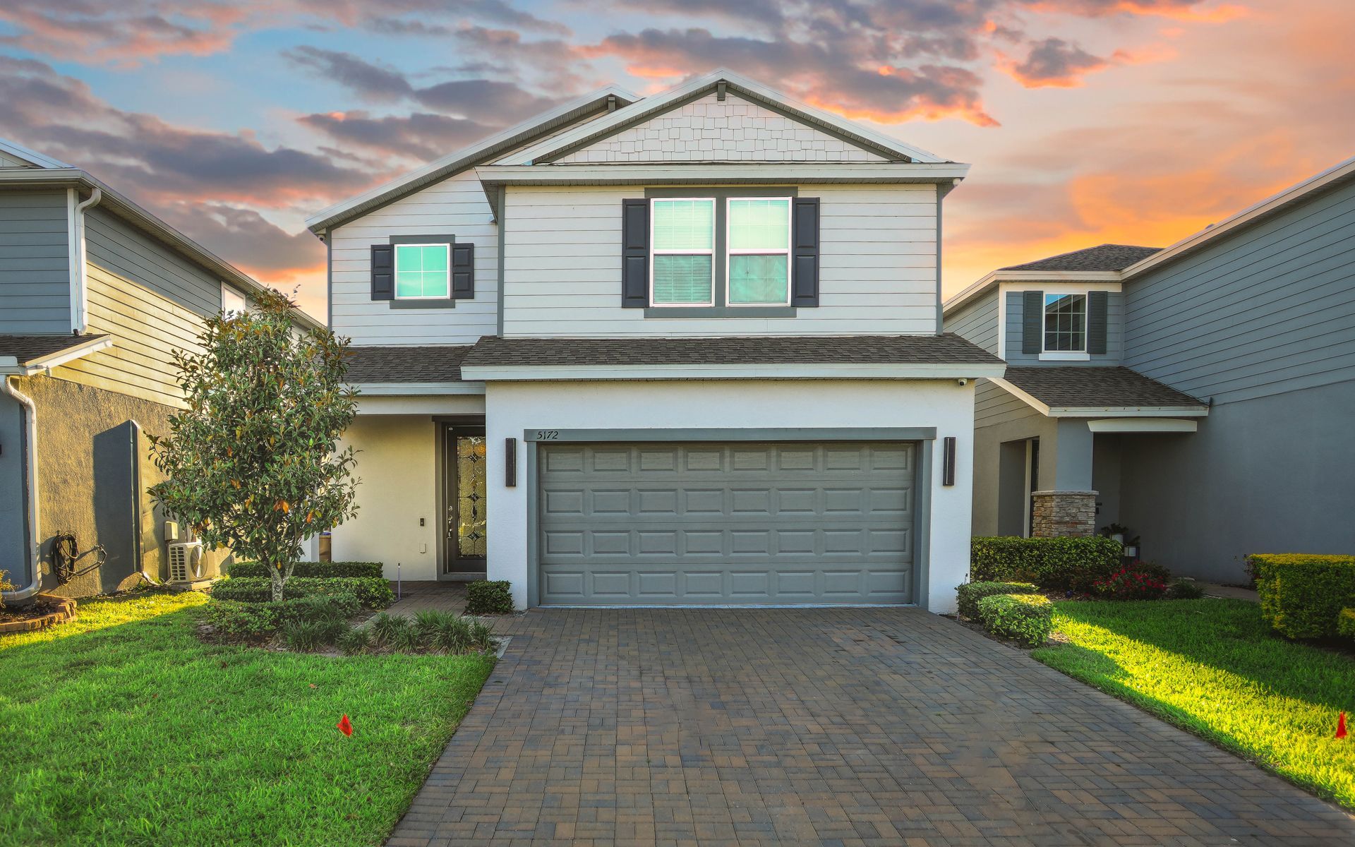 exterior-shot-of-a-white-two-story-house-with-a-ga-2026-03-18-05-41-05-utc