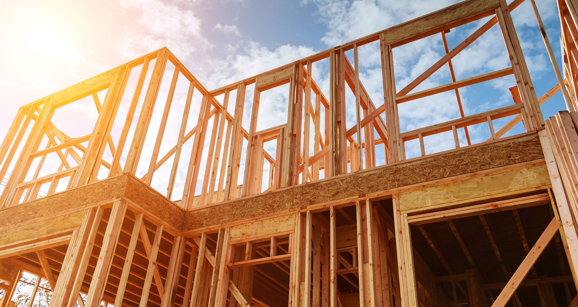 new-residential-construction-home-framing-against-2026-03-25-00-20-50-utc