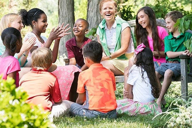A group of children are sitting in a circle with their teacher. - Lancaster, TX - International Harvest Fellowship Ministries
