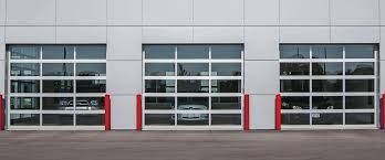 A row of garage doors with a car parked in front of them.