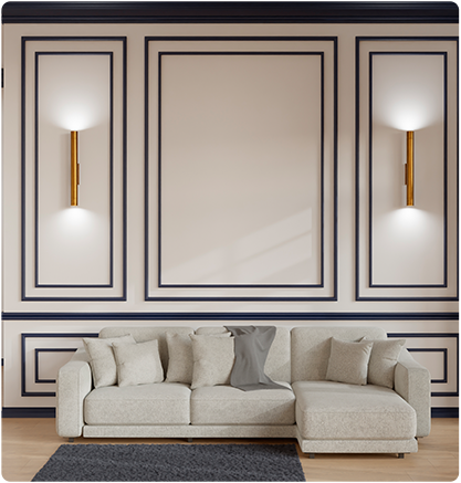 Cream sofa against a wall with black molding and gold sconces; rug on the floor.