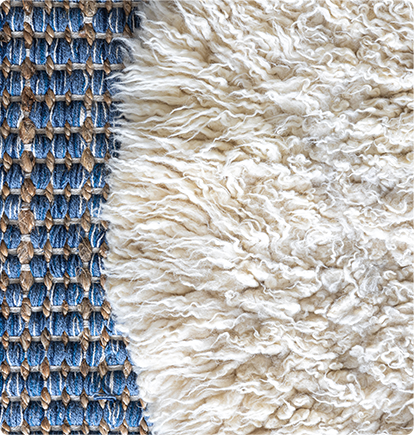 Close-up of a rug with two distinct textures: blue woven pattern and white fluffy material.