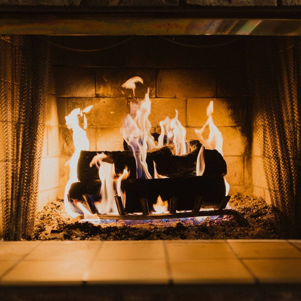 A fireplace with a lot of flames coming out of it