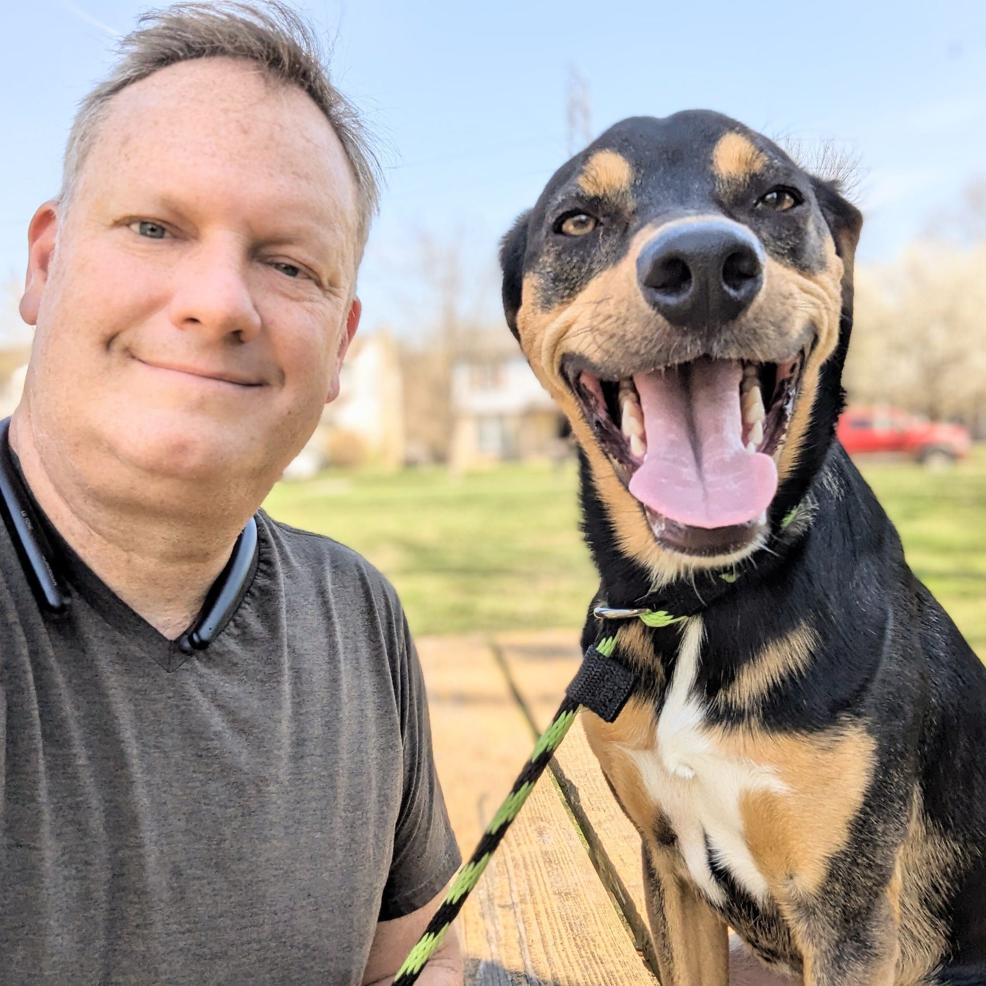 A man and his dog are posing for a picture
