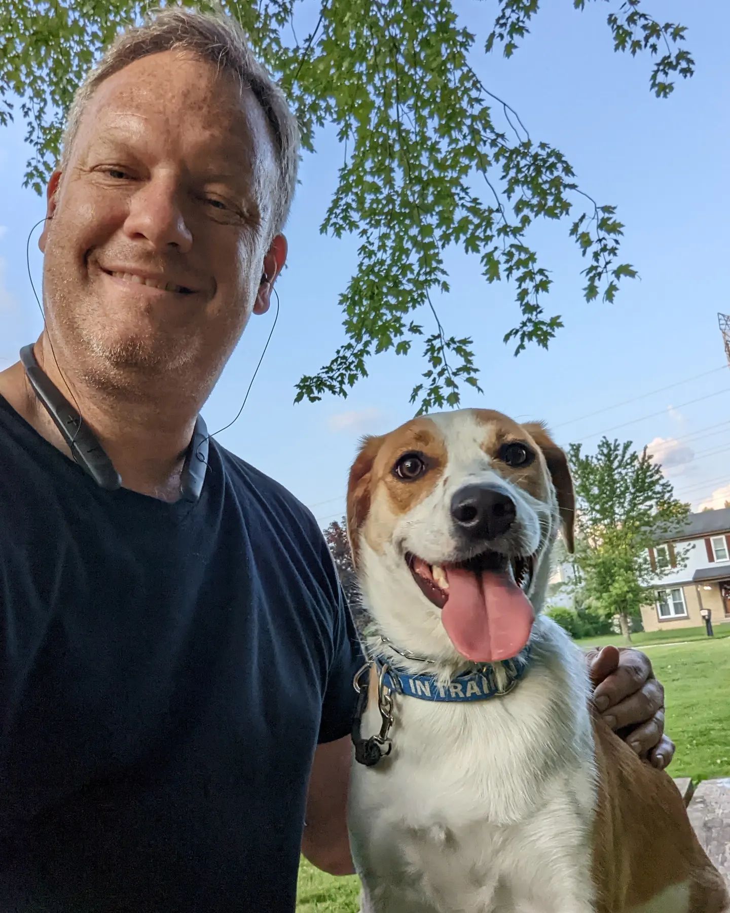 A man and his dog are posing for a picture