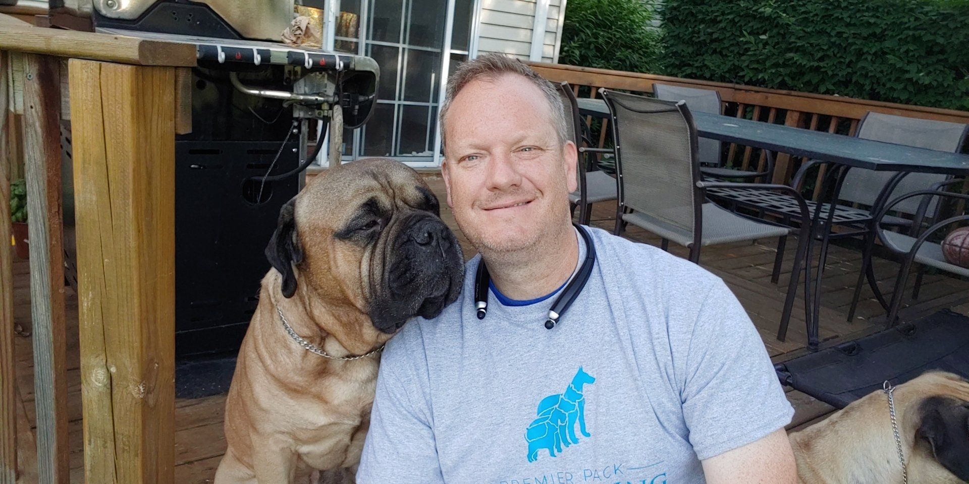 A man and his dog are posing for a picture