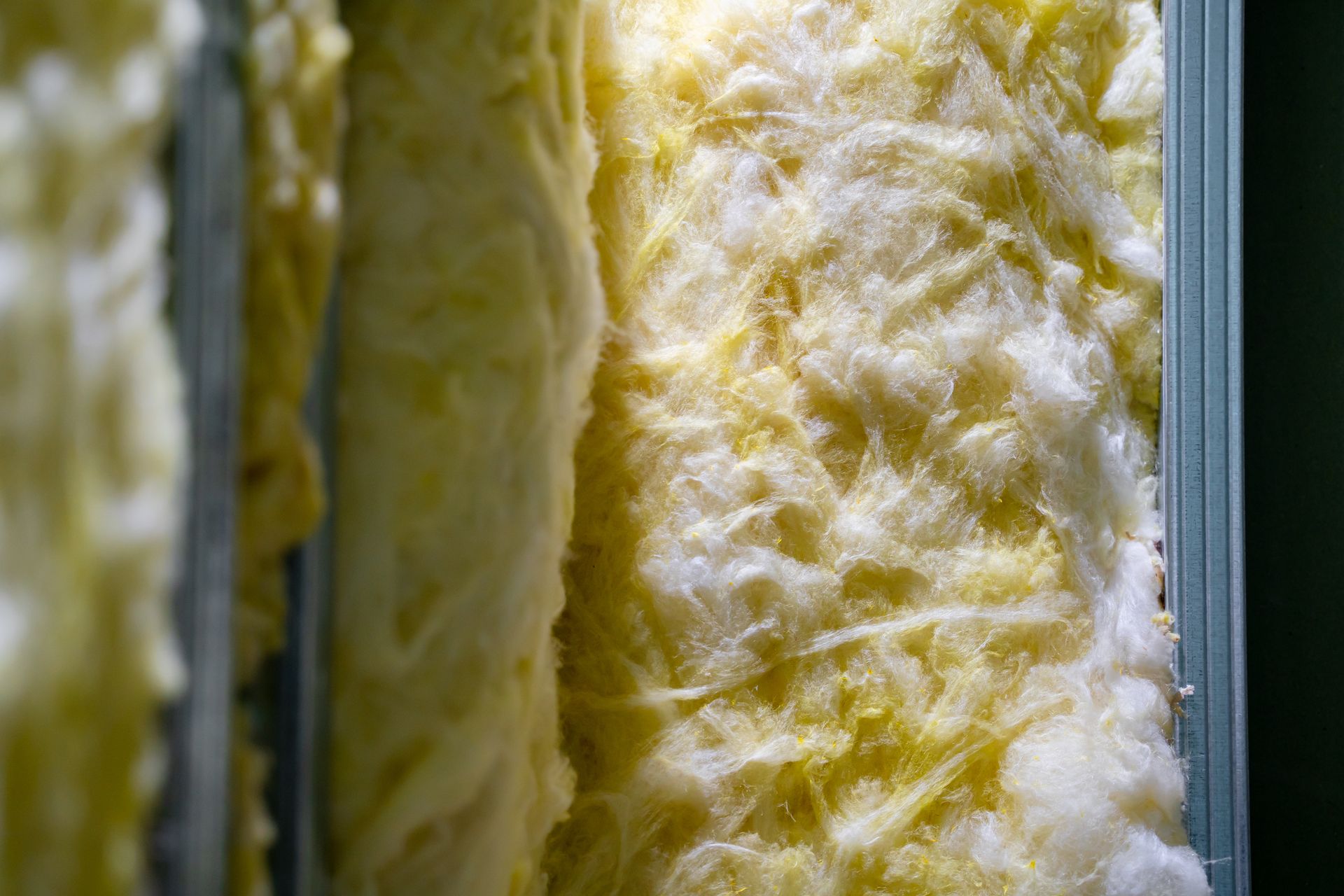 Yellow insulation material inside metal studs.