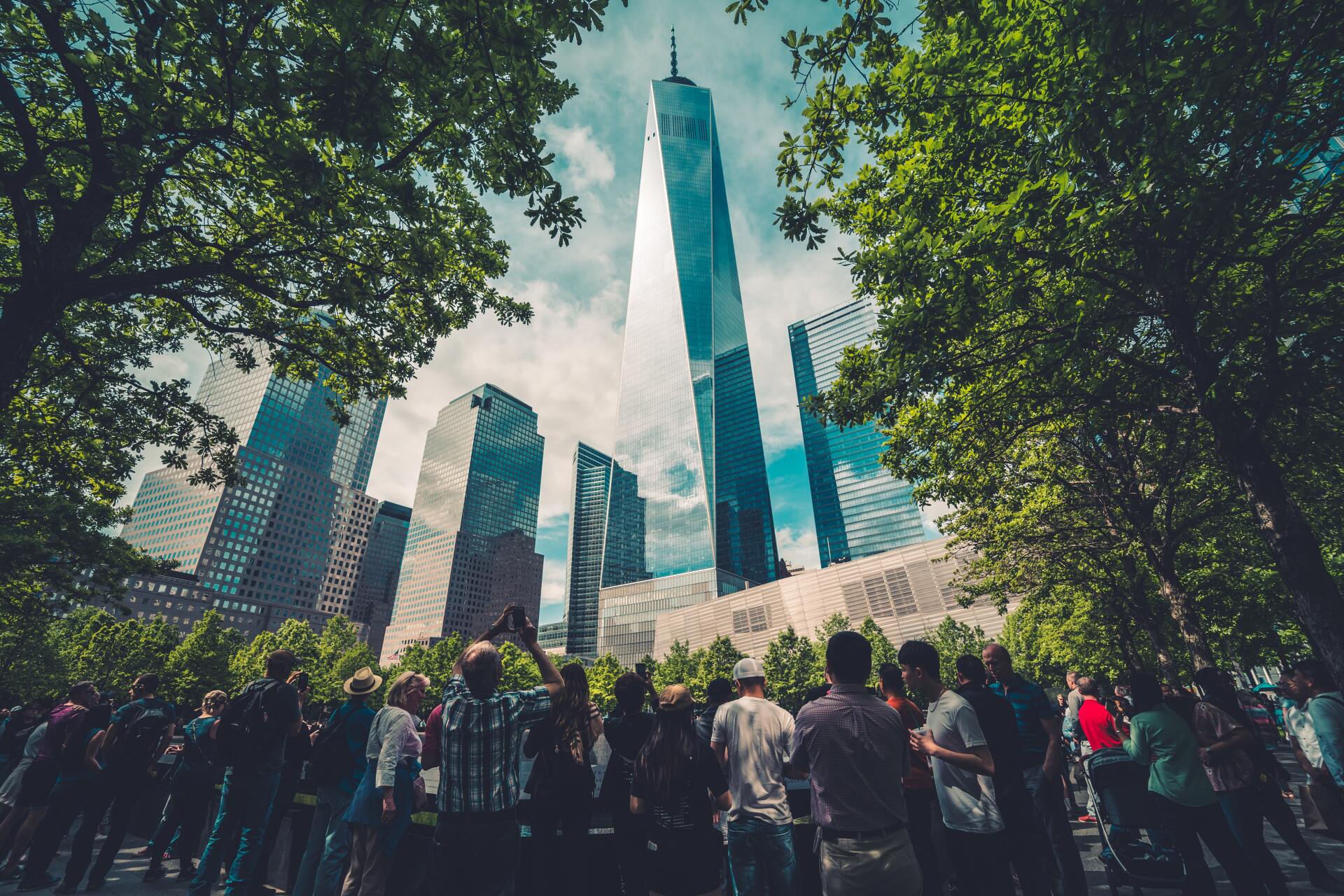 People looking at a building framed by trees