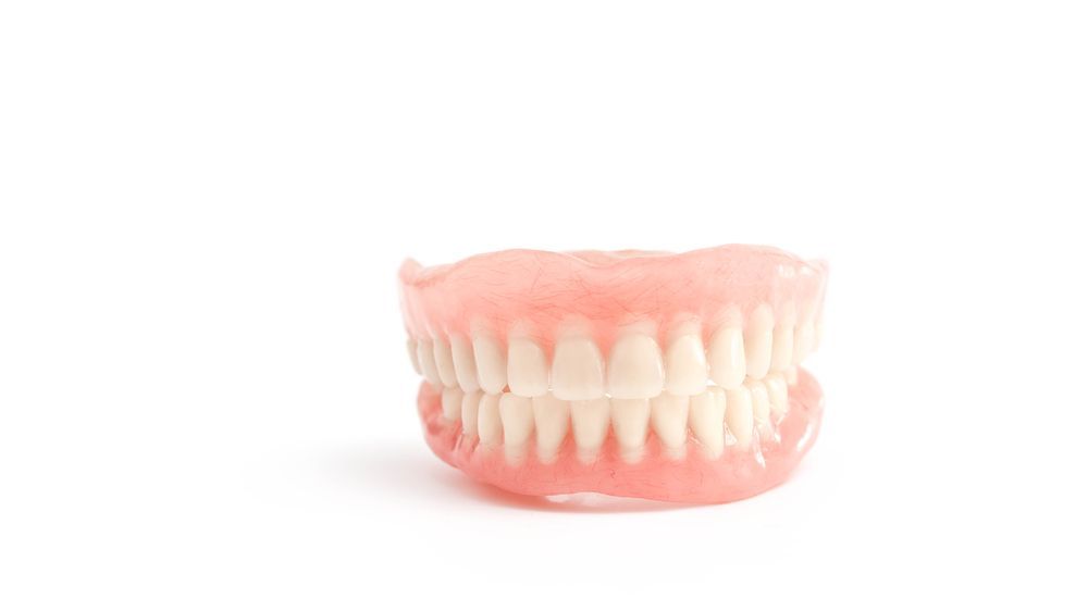 A Close Up Of A Denture On A White Background — Alice Denture Clinic In Ciccone, NT