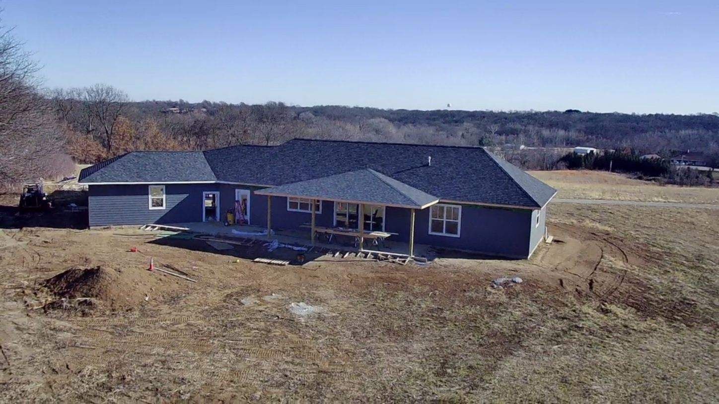 An aerial view of a house under construction in a field.