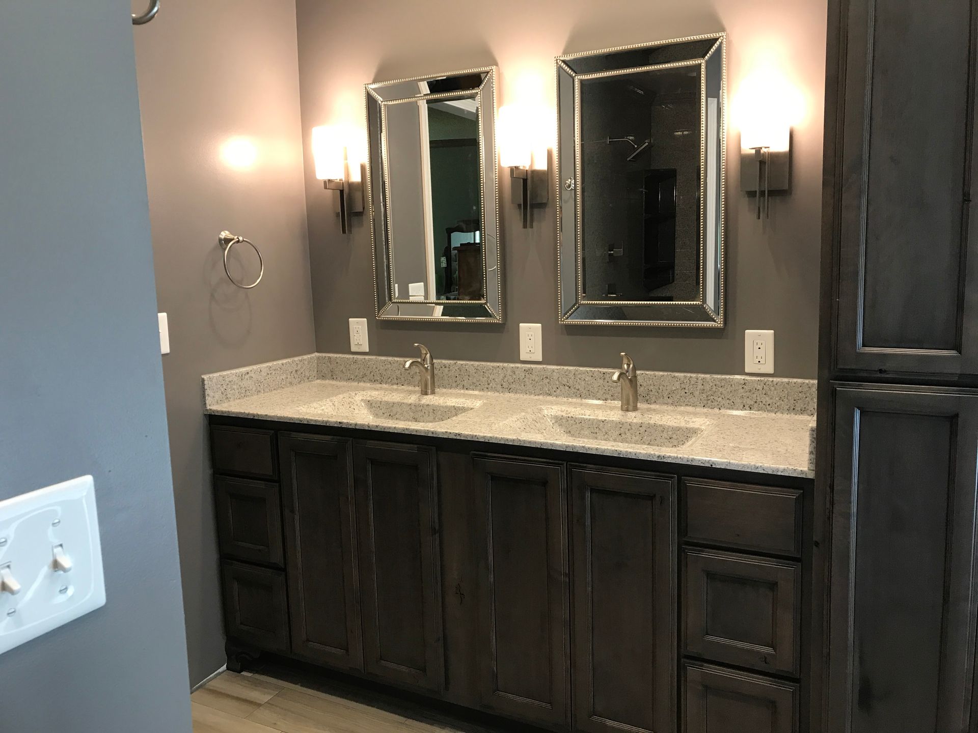 A bathroom with two sinks and two mirrors.