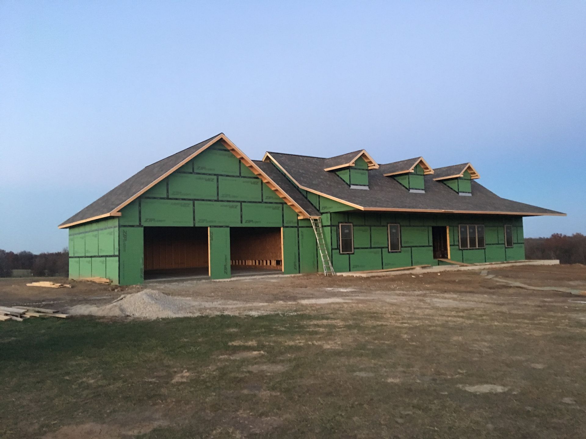 A house that is being built with green siding