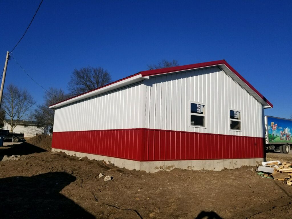 A red and white building with a blue sky in the background