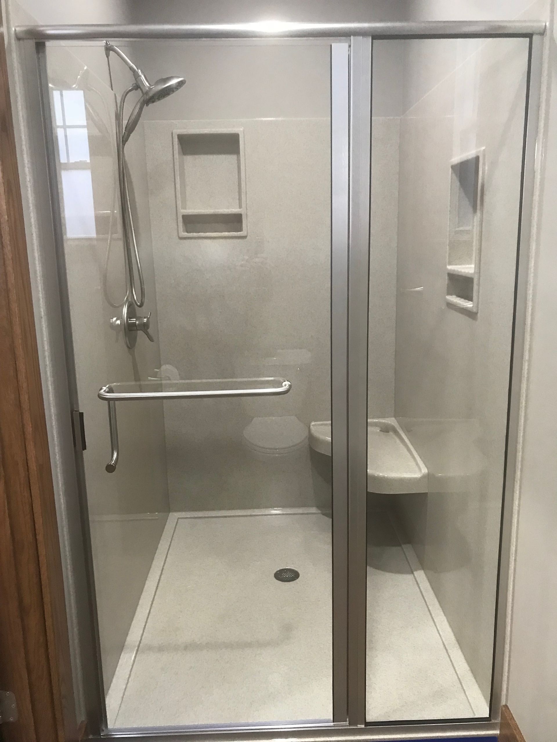 A bathroom with a walk in shower and a toilet.