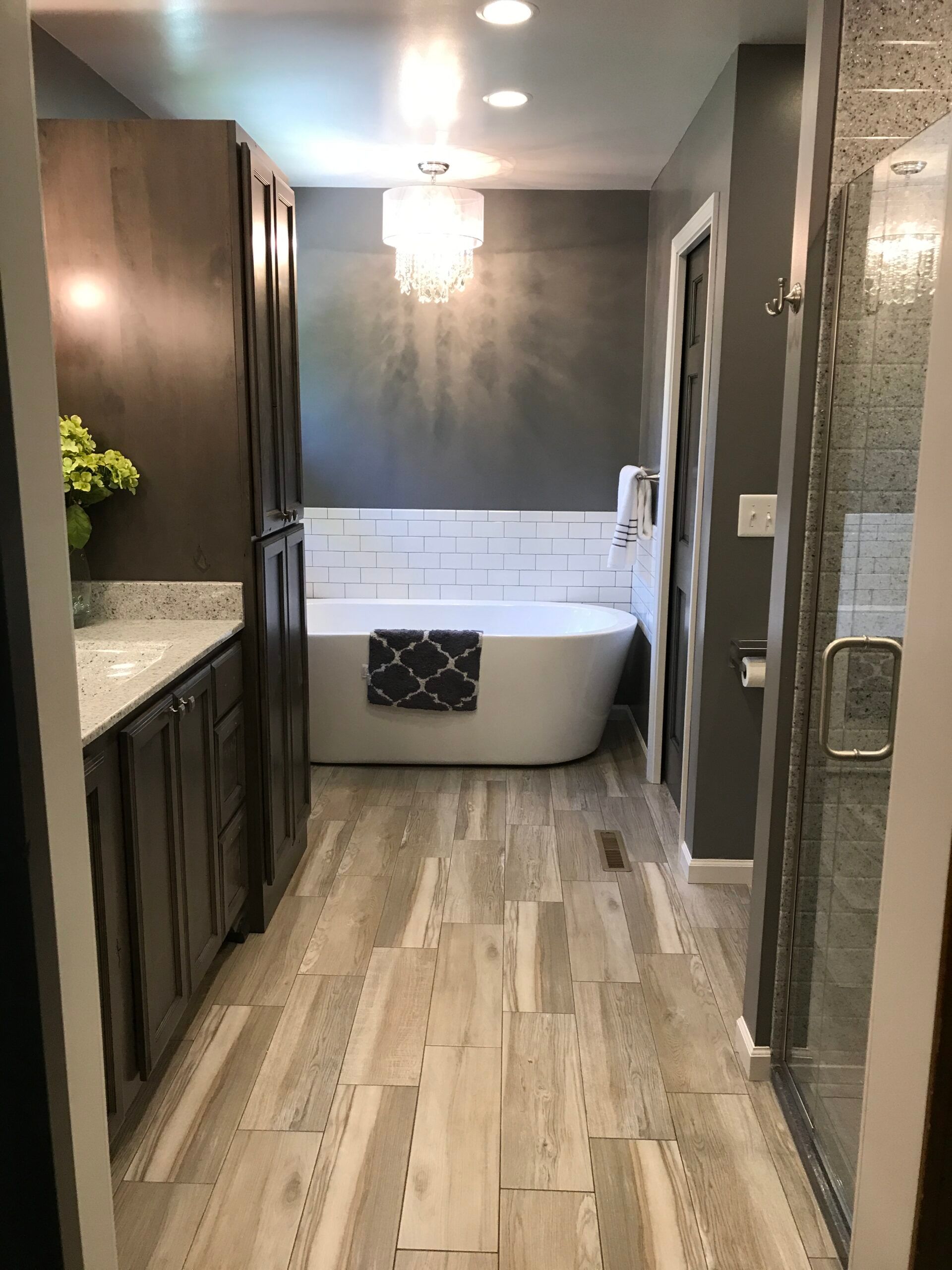 A bathroom with a tub , sink , and shower.