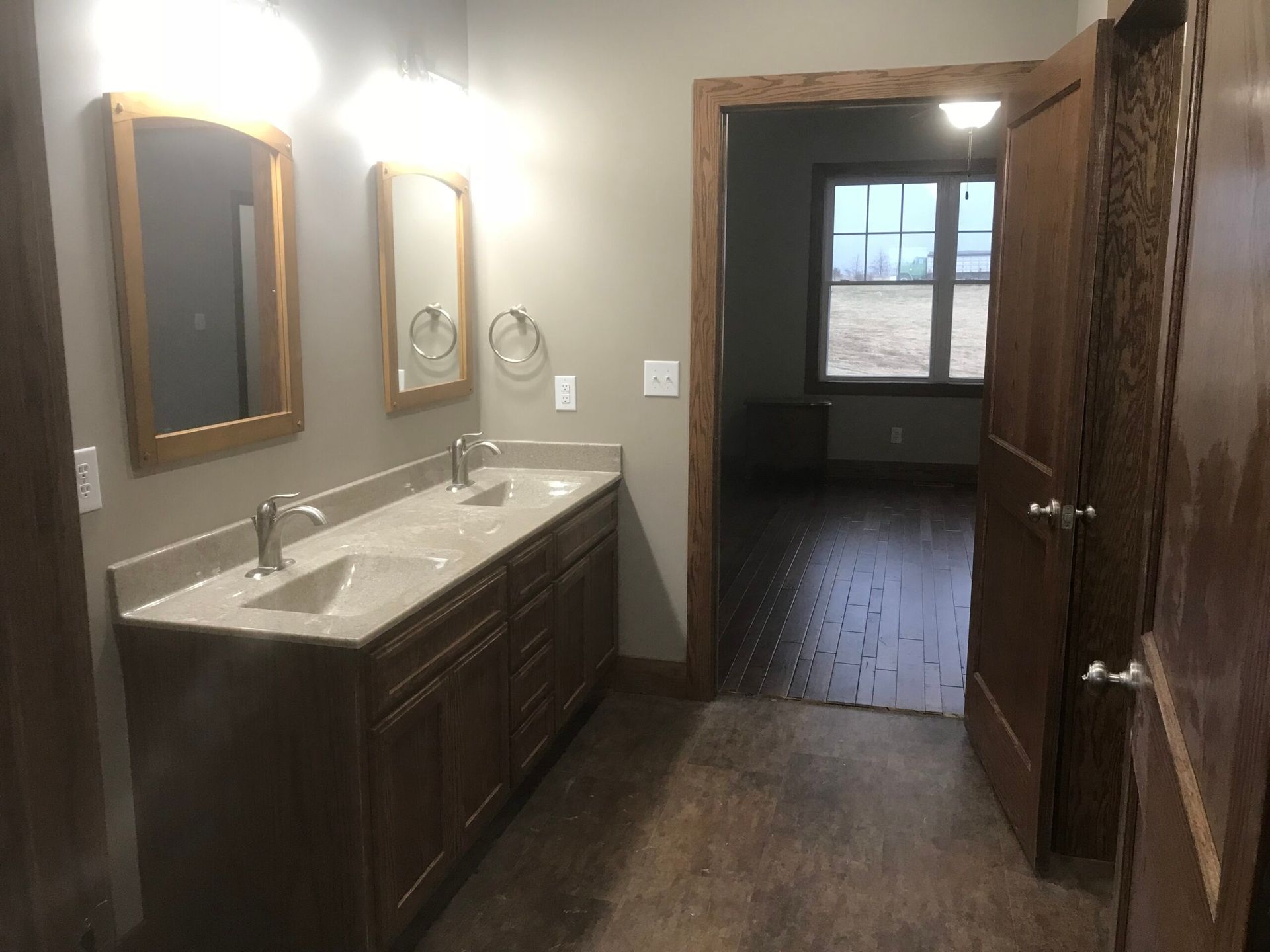 A bathroom with two sinks and two mirrors in a house.