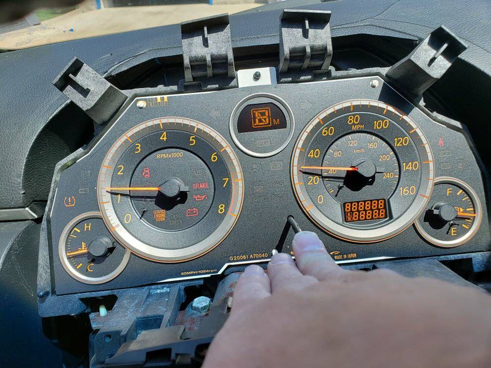 A close up of a person 's hand on a car dashboard