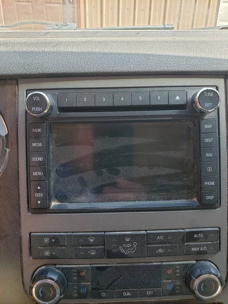 A close up of a car radio in a car.