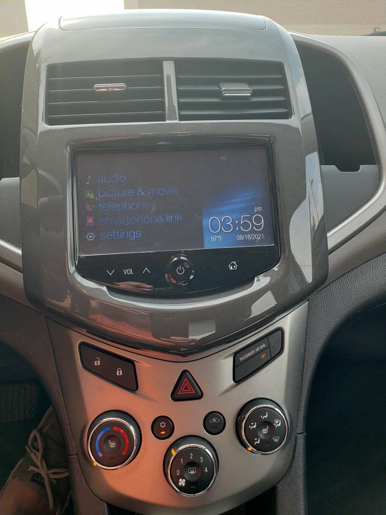 The dashboard of a car with a radio and a clock on it.