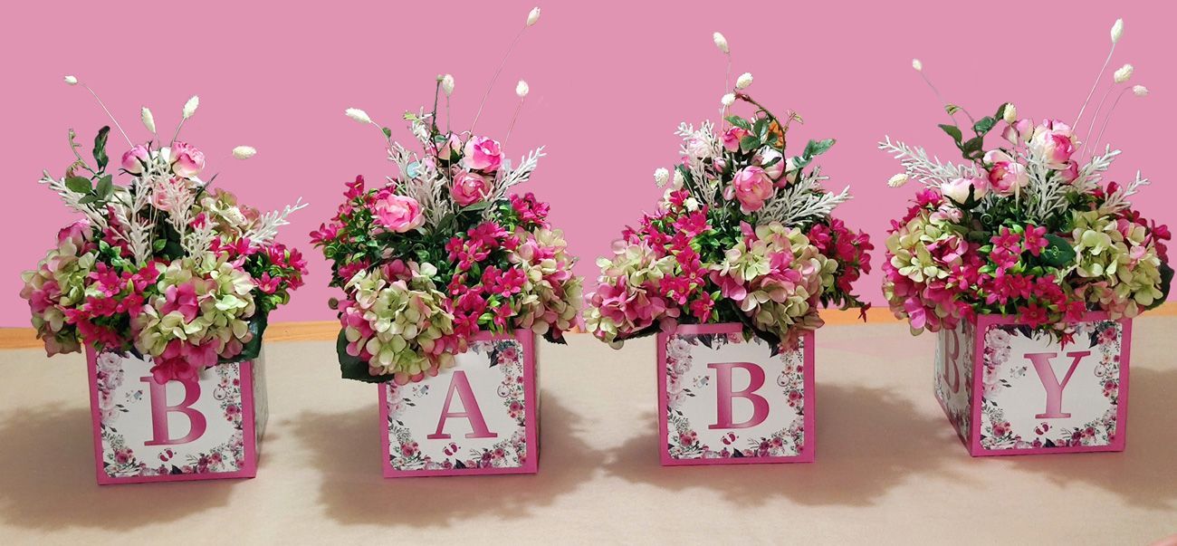 Four floral arrangements spelling
