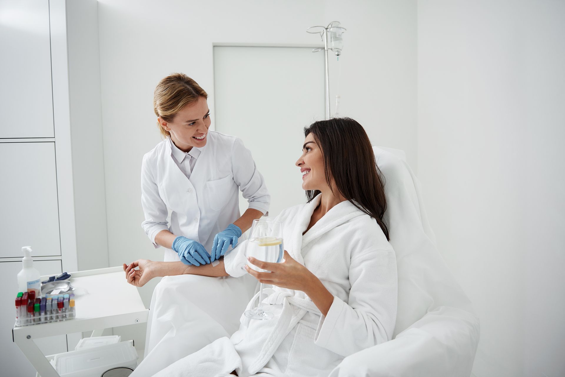 A woman is sitting in a chair getting an injection from a doctor.