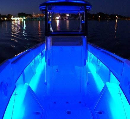 The inside of a boat is lit up with blue lights
