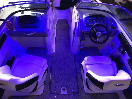 The inside of a boat with blue lights on it.