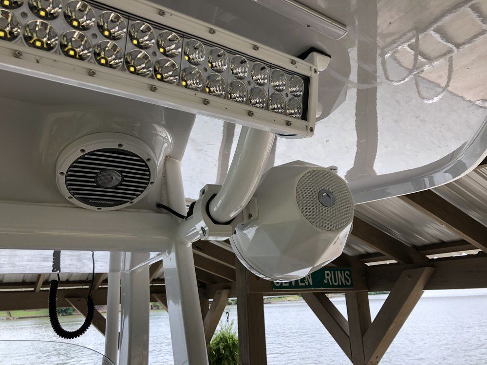 A boat with a speaker and a light on top of it.