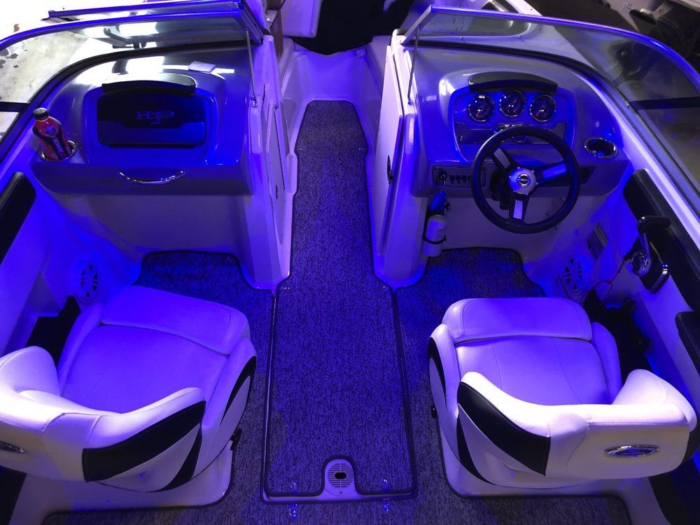 The inside of a boat with blue lights on it