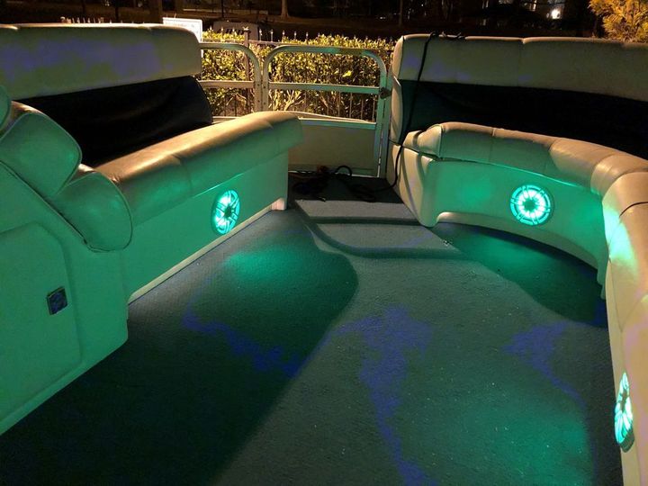 The inside of a boat with green lights on the floor