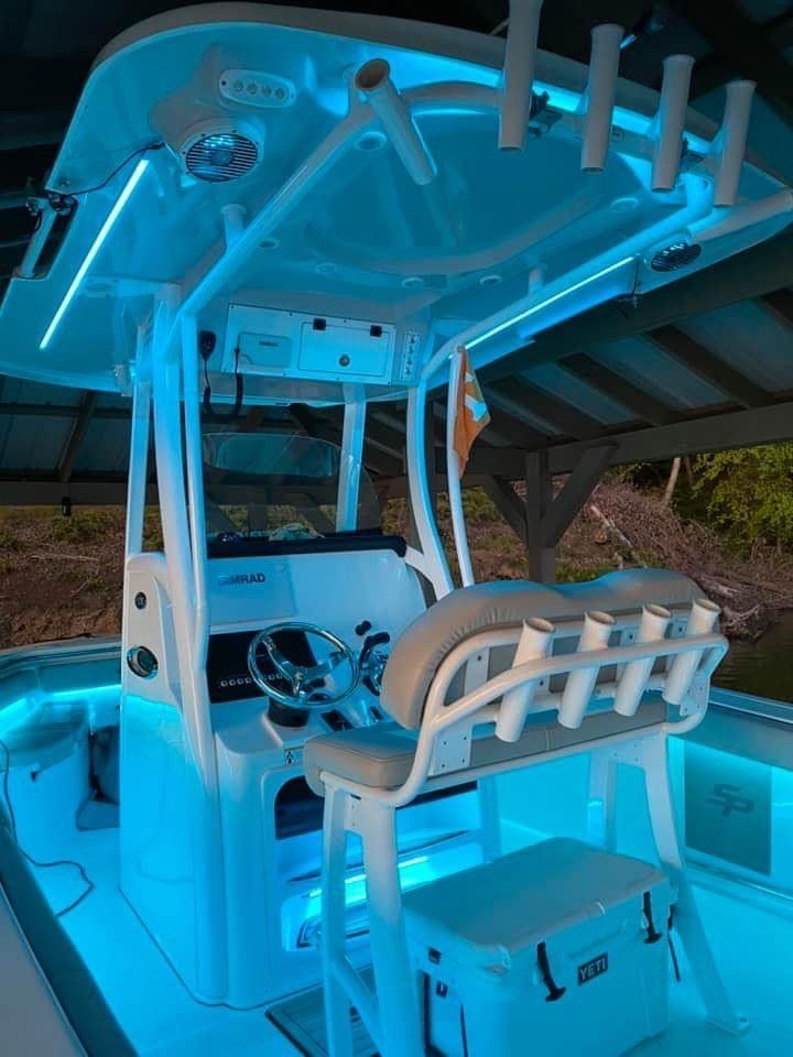 The inside of a boat with blue lights on it.