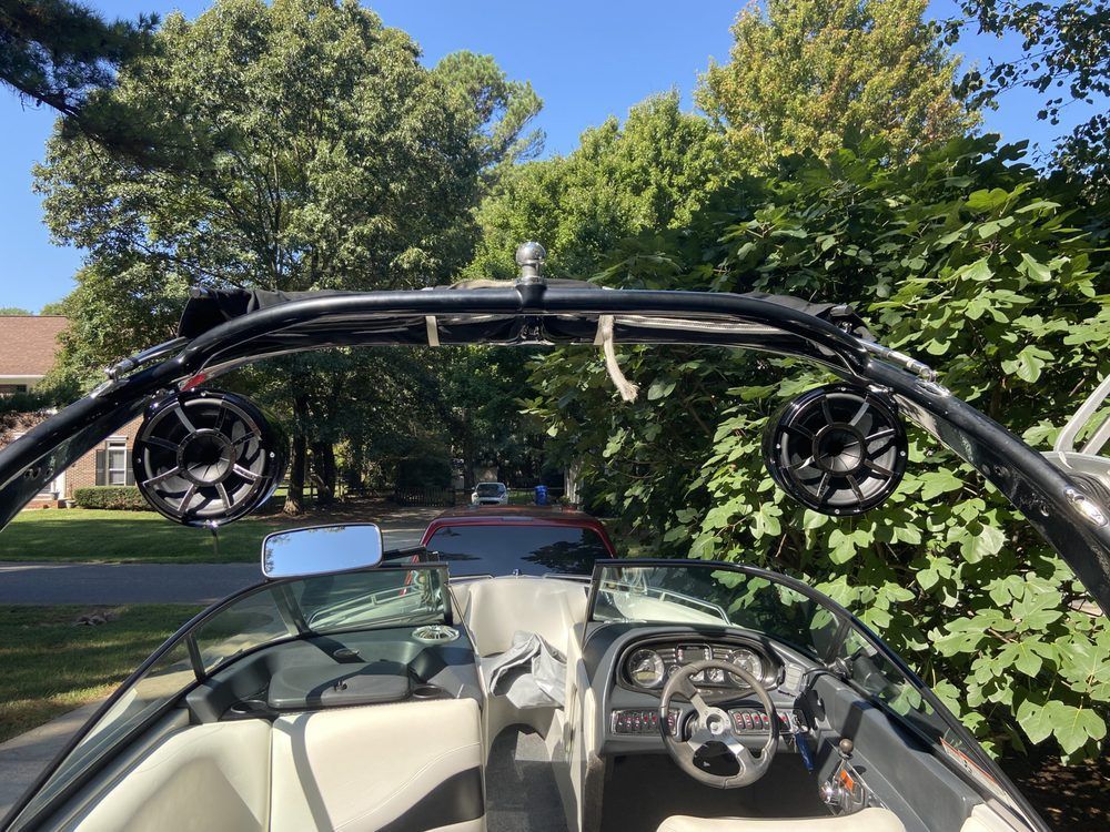 The inside of a boat with speakers on top of it.