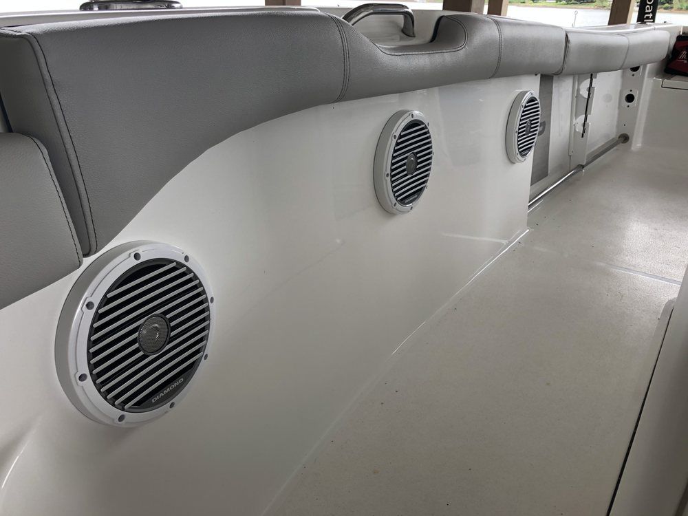 There are three speakers on the side of a boat.