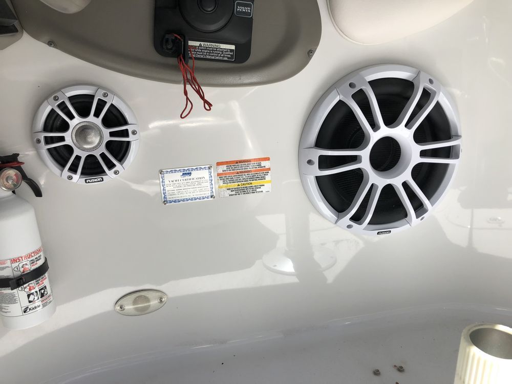 Two speakers are mounted on the side of a boat.