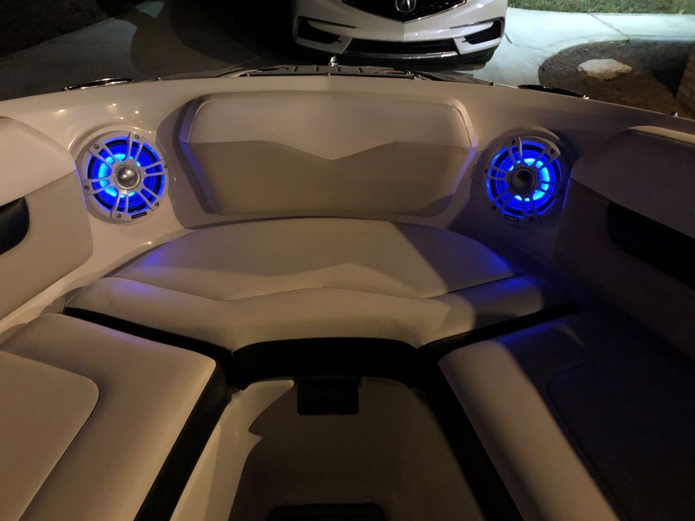 The inside of a boat with blue lights on the speakers