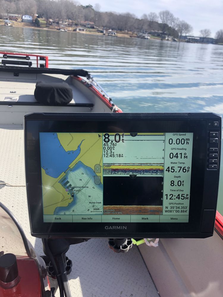 A garmin device is sitting on the side of a boat