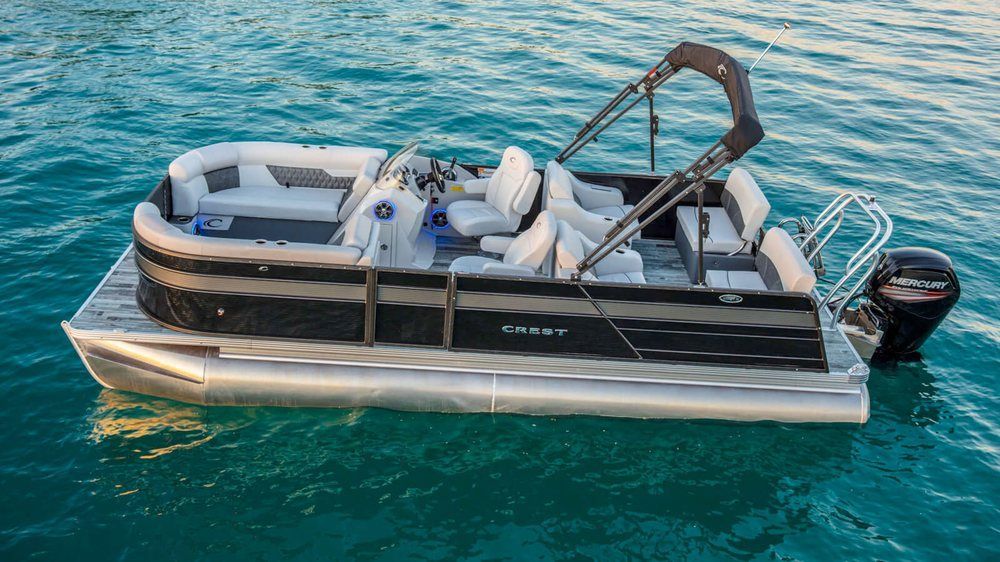 A pontoon boat is floating on top of a body of water.