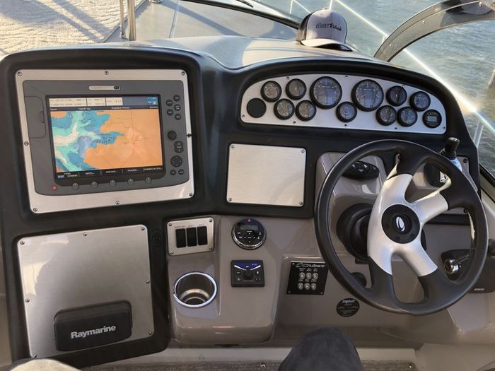 The dashboard of a boat has a raymarine gps on it