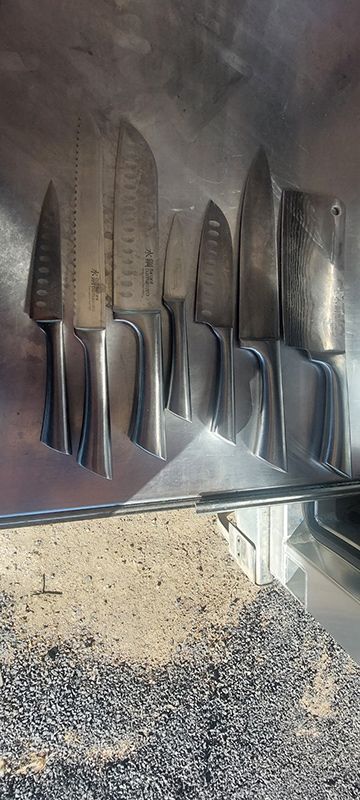 A Bunch of Knives Are Lined Up on a Shelf — Shaving Sharp Knives And Tools in Stanthorpe, QLD
