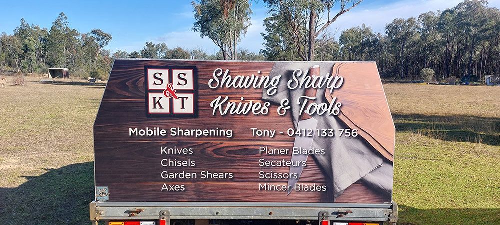 A Truck With a Sign on the Back That Says Shaving Sharp Knives and Tools — Shaving Sharp Knives And Tools in Centenary Heights, QLD