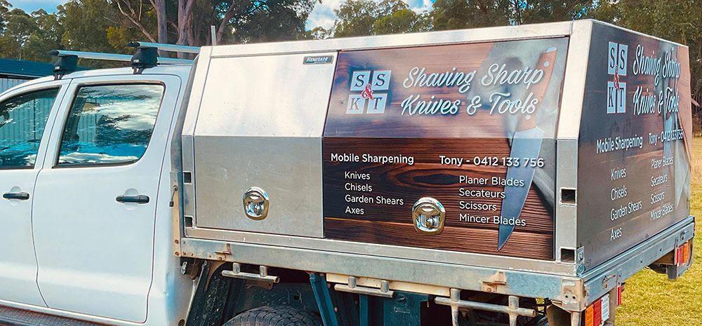 A White Truck is Parked in a Grassy Field — Shaving Sharp Knives And Tools in Centenary Heights, QLD