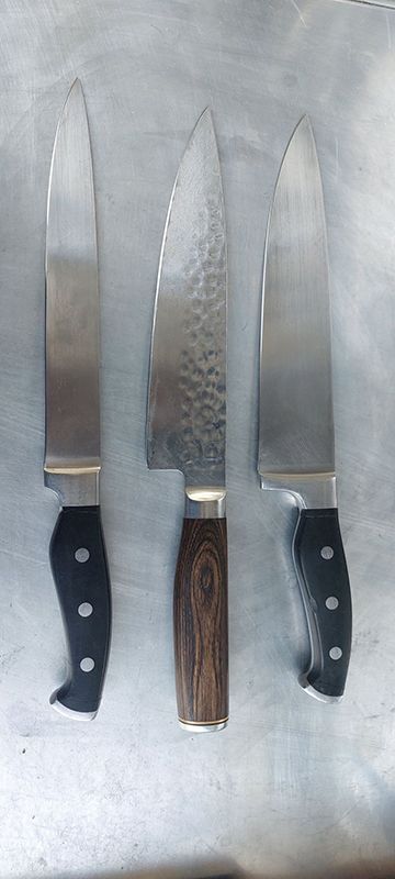 Three Knives Are Sitting Next to Each Other on a Table — Shaving Sharp Knives And Tools in Centenary Heights, QLD