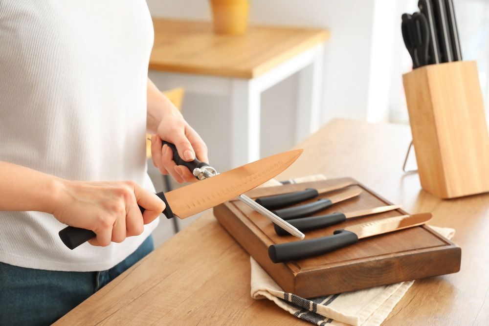 A Woman Organizing Her Kitchen Knives — Shaving Sharp Knives And Tools in Gatton, QLD