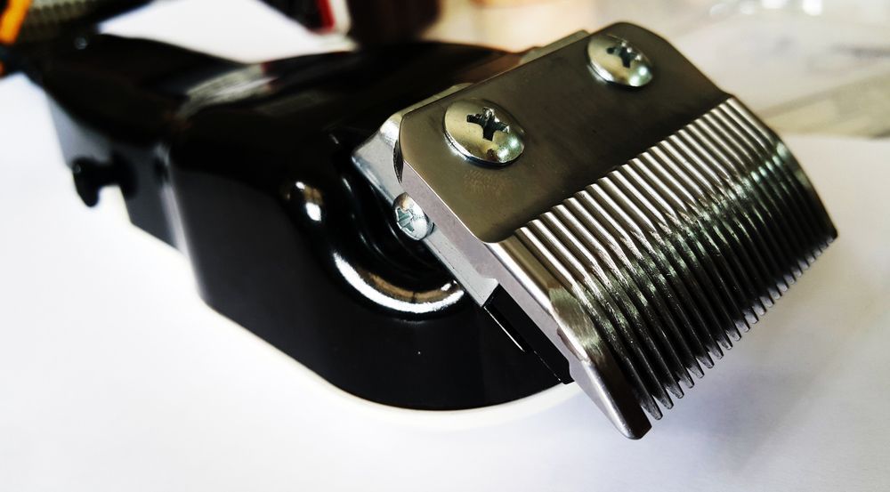 A Close Up Of A Hair Clipper Blade On A White Surface — Shaving Sharp Knives And Tools in Centenary Heights, QLD