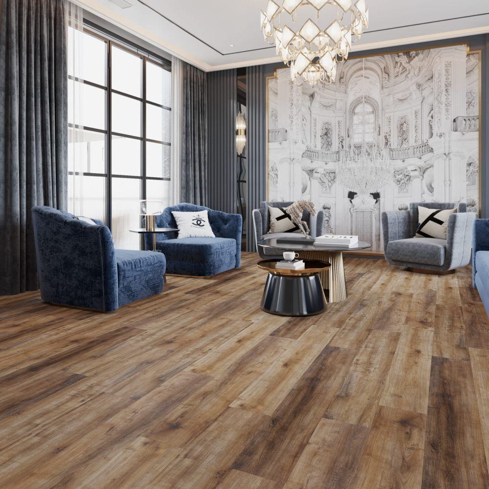 Living room with blue velvet chairs, wood floors, large window, and ornate chandelier.